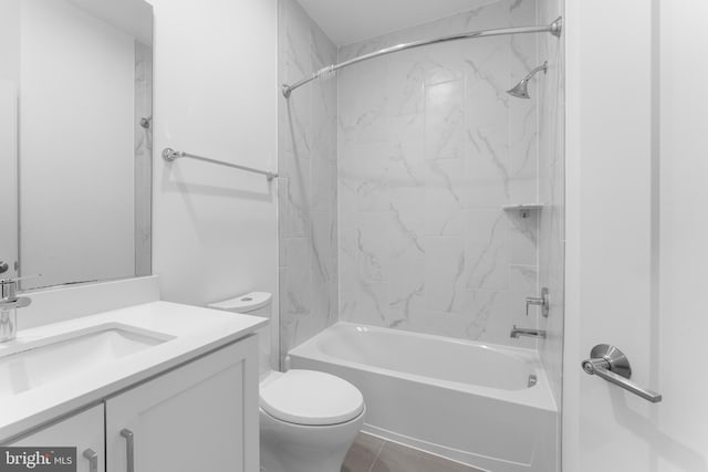 full bathroom featuring tile patterned floors, toilet, vanity, and tiled shower / bath