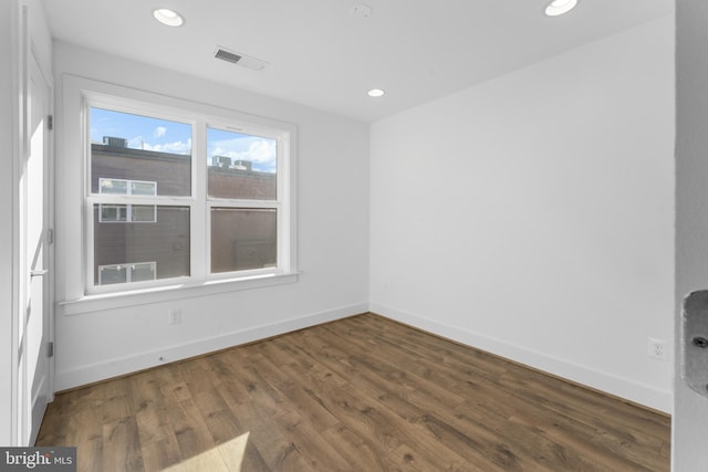 unfurnished room with dark hardwood / wood-style floors