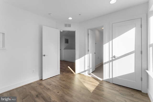 empty room featuring dark hardwood / wood-style flooring