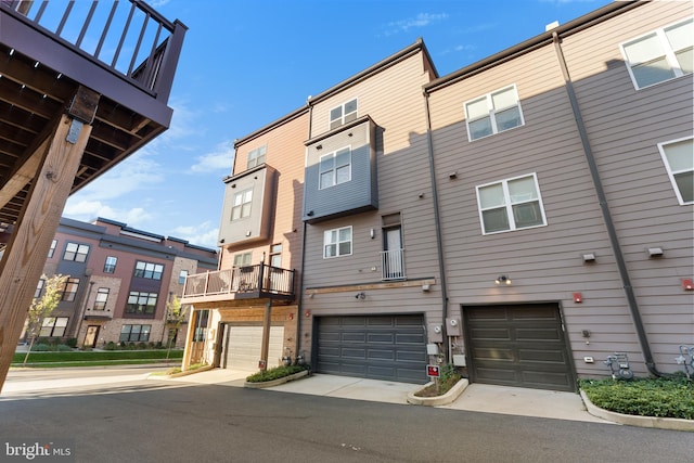 exterior space with a garage and a balcony