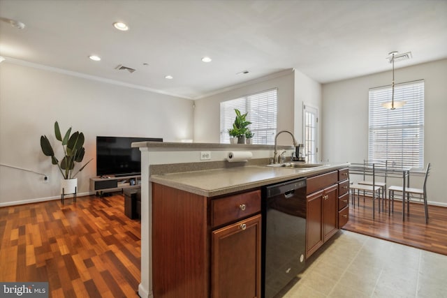 kitchen with pendant lighting, an island with sink, sink, dishwasher, and light hardwood / wood-style floors