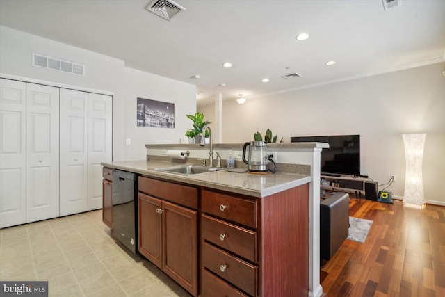 kitchen featuring dishwasher, light hardwood / wood-style floors, sink, a center island with sink, and ornamental molding