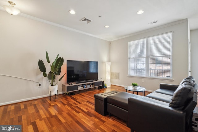 living room featuring hardwood / wood-style floors and crown molding