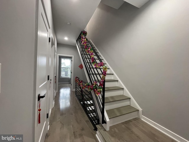 stairway with hardwood / wood-style floors