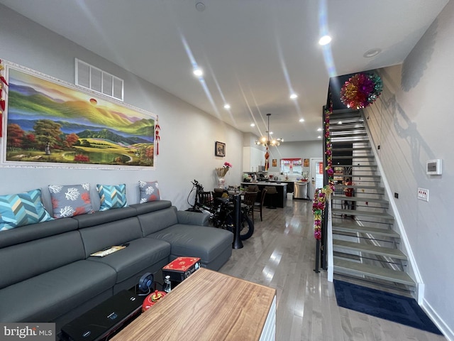 living room featuring a chandelier and light hardwood / wood-style floors