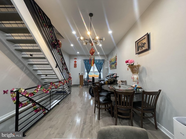 dining space featuring an inviting chandelier and hardwood / wood-style flooring