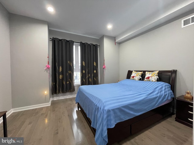 bedroom with wood-type flooring