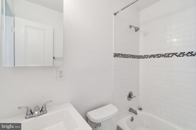 full bathroom featuring vanity, tiled shower / bath combo, and toilet