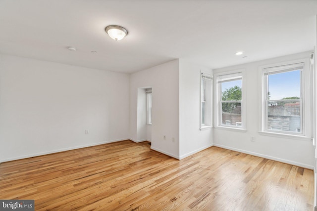 spare room featuring light hardwood / wood-style floors