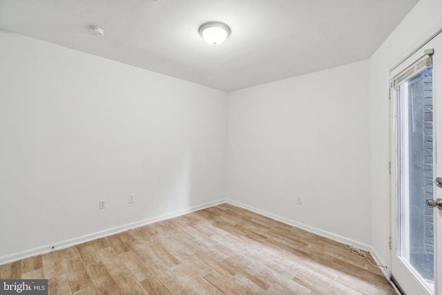 empty room with light hardwood / wood-style flooring