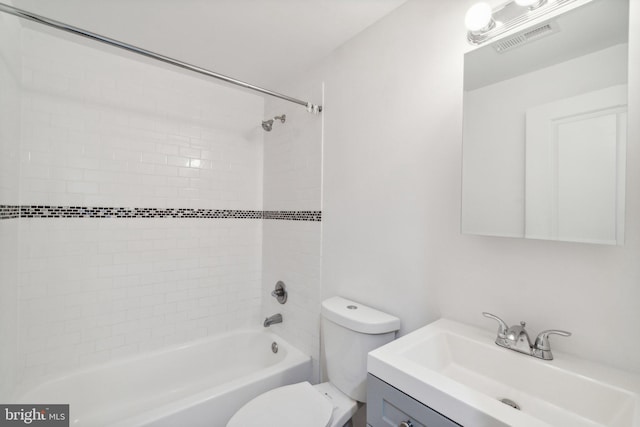 full bathroom with vanity, tiled shower / bath combo, and toilet