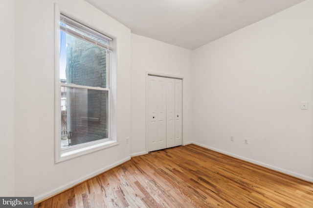 empty room with light hardwood / wood-style floors