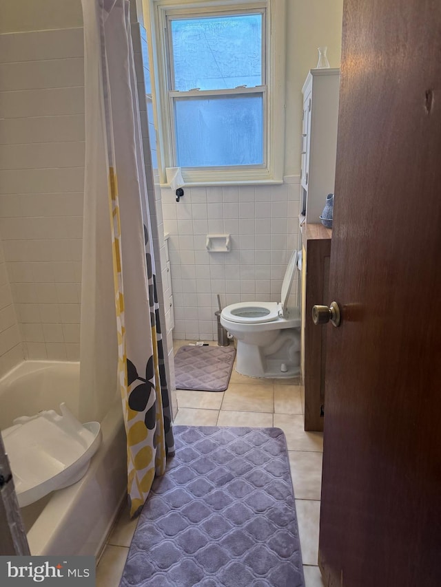 bathroom featuring shower / bath combo, tile walls, tile patterned flooring, and toilet