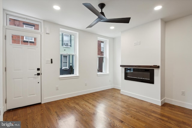 entrance foyer featuring ceiling fan, hardwood / wood-style flooring, and heating unit