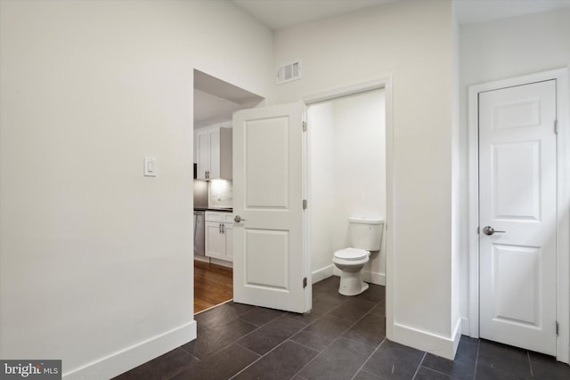 bathroom featuring wood-type flooring and toilet