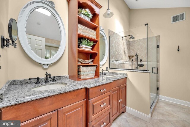 bathroom featuring a shower with door, vaulted ceiling, vanity, and tile patterned floors