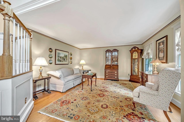 living room featuring light wood-type flooring and crown molding