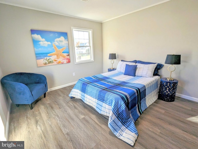 bedroom featuring hardwood / wood-style flooring and ornamental molding