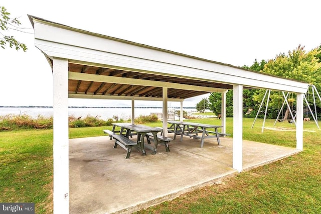 view of patio featuring a gazebo and a water view