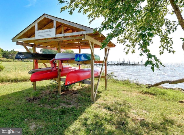 view of play area with a yard and a water view