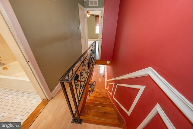 stairs featuring wood-type flooring