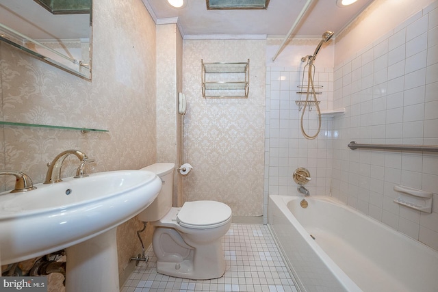 full bathroom featuring tiled shower / bath, sink, tile patterned floors, crown molding, and toilet