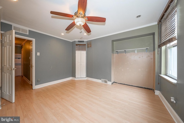 unfurnished bedroom featuring light hardwood / wood-style floors, ceiling fan, and crown molding