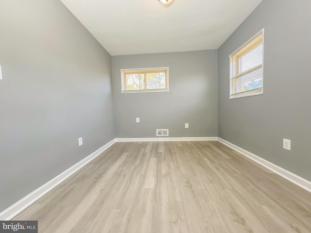 unfurnished room with light hardwood / wood-style floors