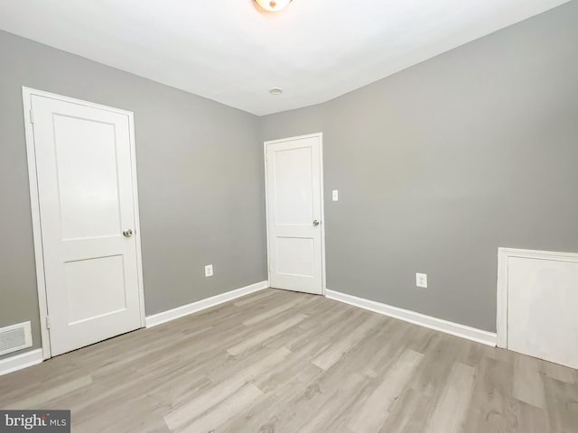 spare room featuring light hardwood / wood-style floors