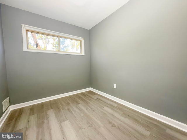 empty room with light hardwood / wood-style floors