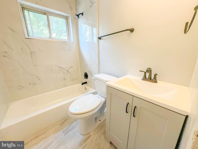 full bathroom featuring tiled shower / bath combo, vanity, and toilet