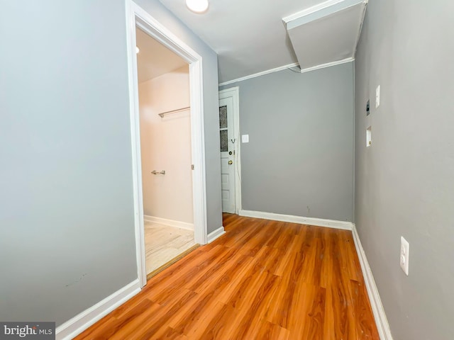 interior space with ornamental molding and light hardwood / wood-style floors