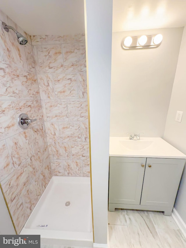 bathroom featuring vanity and tiled shower