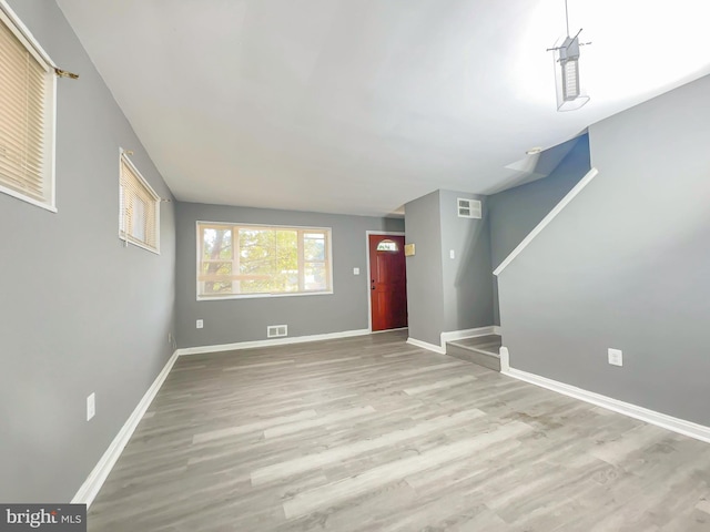 unfurnished living room featuring light wood-type flooring