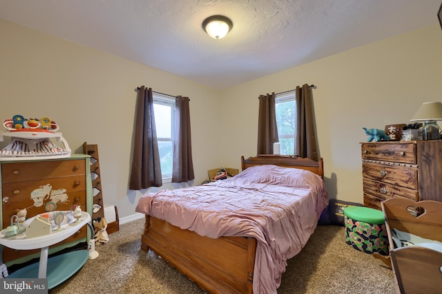 carpeted bedroom with a textured ceiling