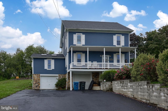 view of front facade featuring a porch and a garage