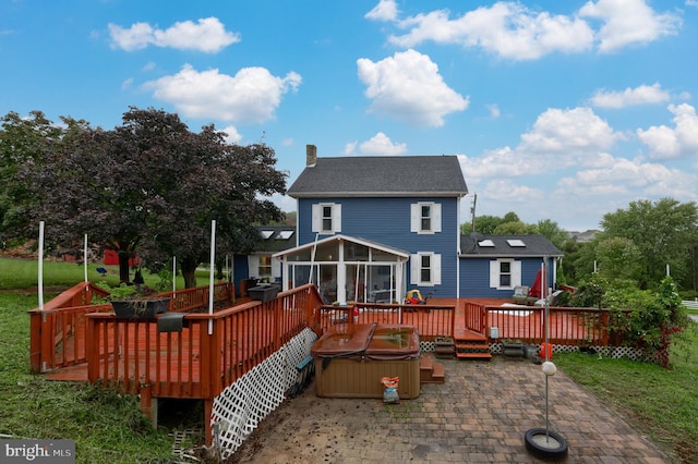 rear view of house featuring a sunroom, a patio, a hot tub, and a deck