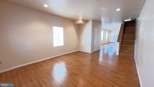 spare room featuring wood-type flooring