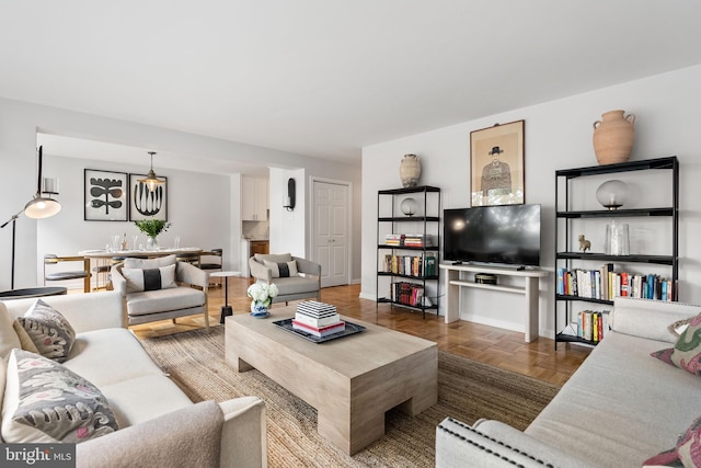 living room featuring parquet flooring