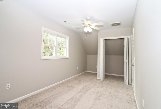 additional living space with ceiling fan, lofted ceiling, and light colored carpet