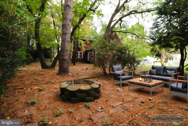 view of yard featuring an outdoor living space with a fire pit and a patio