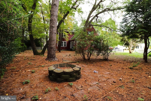 view of yard with a fire pit