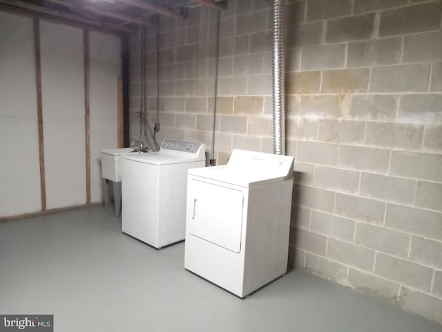 washroom featuring washer and dryer and sink