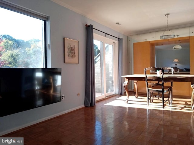 dining space featuring dark parquet flooring