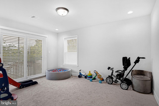 rec room featuring carpet, visible vents, baseboards, and recessed lighting