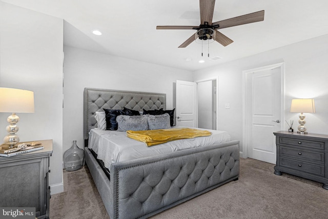 carpeted bedroom with a ceiling fan and recessed lighting