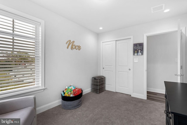 interior space featuring baseboards, visible vents, dark colored carpet, a closet, and recessed lighting