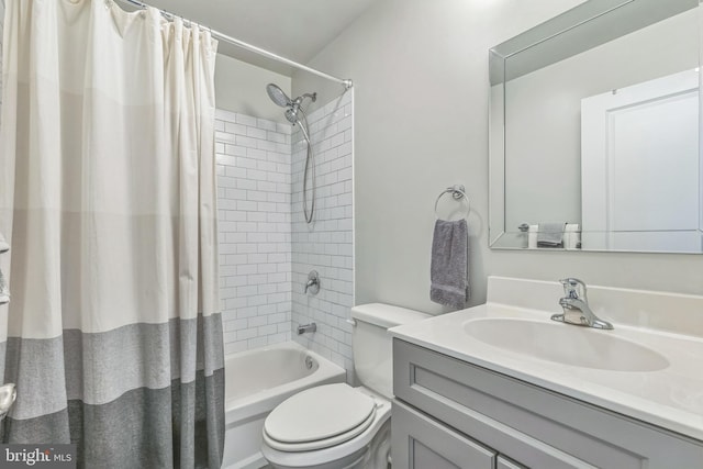 bathroom with toilet, shower / bath combo with shower curtain, and vanity