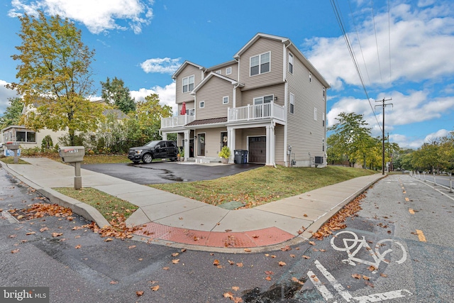 view of front of house with a garage and a balcony