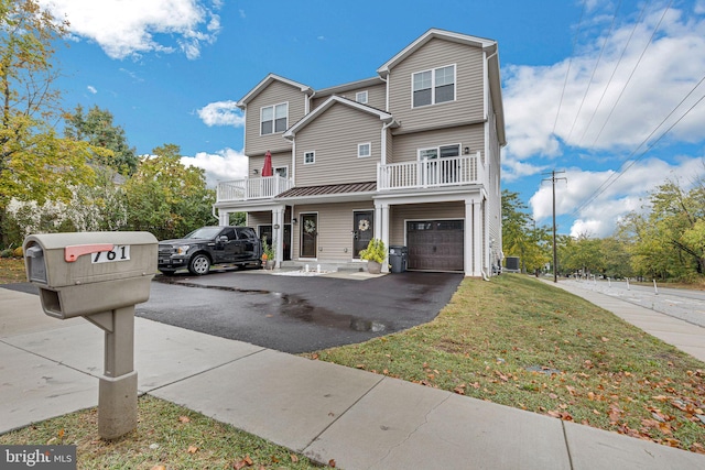 view of front of home with a balcony, a garage, and a front lawn